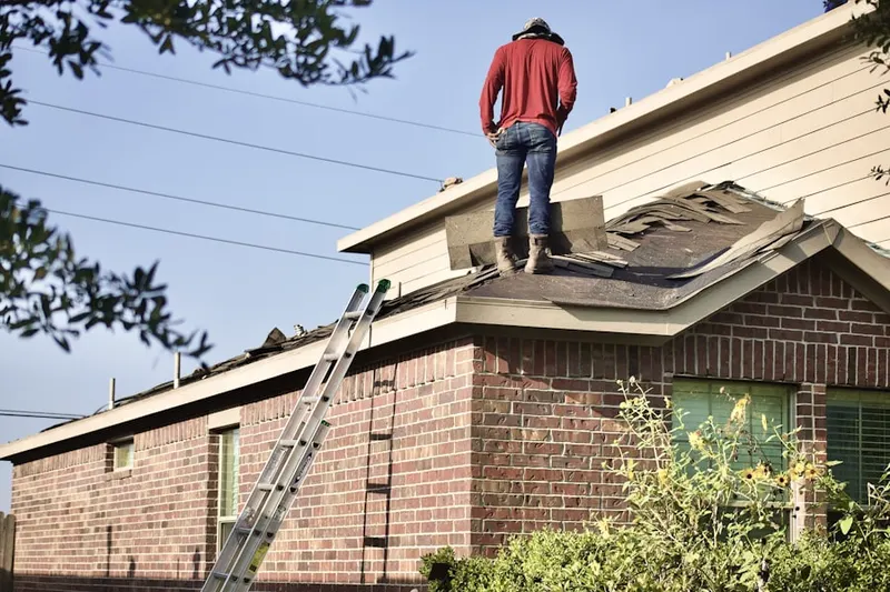 Professional roofer working on a residential roof in Downtown Winston-Salem